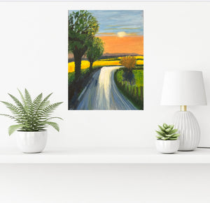 Room mock-up of painting on a white shelf with plants. Painting Image of a tree lined country road leading to bright yellow crop filled fields and a golden sunset beyond.  