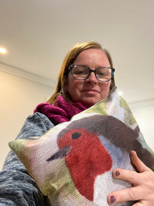 Artist Leonora holding Robin cushion for size reference 
