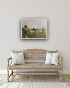 Hallway image of wooden bench with wooden effect framed painting overhead.  
