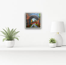 Load image into Gallery viewer, Image of painting in a grey white frame on a white wall over a shelf with potted plants