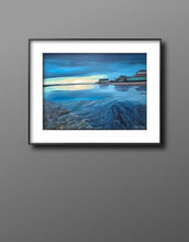 Load image into Gallery viewer, Moody blue oil painting of Nanny Cott    age alongside the Nanny river in Laytown, Co Meath,  Sunrise orangey sky with dark blue clouds reflected in the water below.  THe ripples of the sand under the water in the foreground leads the eye in to the middle of the painting and the reflections of the thatched cottage and house..Photo by Tony Campbell, used with permission.  art for sale.  gift ideas.  Ireland. Meath.  scenic, atmospheric