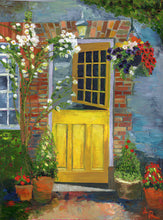 Load image into Gallery viewer, image of yellow door with flowers cascading down around the opening and in pots on the ground