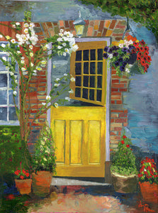 image of yellow door with flowers cascading down around the opening and in pots on the ground