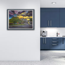 Load image into Gallery viewer, light wood frame on the Millmount Tower sunrise painting in the Room Setting image of a blue kitchen
