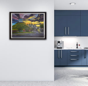 Room setting of a kitchen with the framed image of the Millmount Tower at sunrise on the wall in the foreground